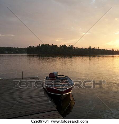 Motorboat at the dock in Lake of the Woods, Ontario View Large Photo Image Picture - Motorboat at the dock in Lake of the Woods, Ontario. Fotosearch