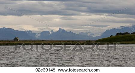 Mountains and glaciers of Iceland, with grassland, and a shed, from the coastline View Large Photo Image Stock Photography - Mountains and glaciers of Iceland, with grassland, and a shed, from the coastline. Fotosearch