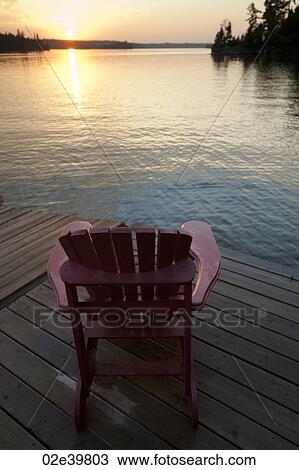 Muskoka chair on a dock at sunset in Lake of the Woods, Ontario View Large Photo Image Stock Image - Muskoka chair on a dock at sunset in Lake of the Woods, Ontario. Fotosearch