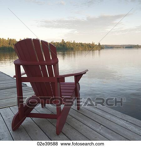 Muskoka chair on dock at Lake of the Woods, Ontario View Large Photo Image Stock Photo - Muskoka chair on dock at Lake of the Woods, Ontario. Fotosearch