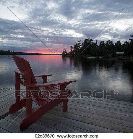 Muskoka chair on the dock at sunset in Lake of the Woods, Ontario View Large Photo Image Stock Image - Muskoka chair on the dock at sunset in Lake of the Woods, Ontario. Fotosearch