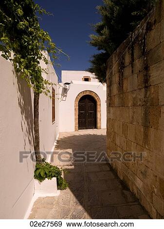 Stock Photo - Narrow street in Rhodes Greece. Fotosearch