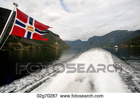 Norwegian flag on a ship in the fjord, Aurlandsfjord, Sognefjord, Norway View Large Photo Image Stock Photo - Norwegian flag on a ship in the fjord, Aurlandsfjord, Sognefjord, Norway. Fotosearch