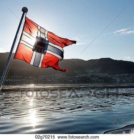 Stock Photography - Norwegian flag on the edge of a boat, Norway. Fotosearch