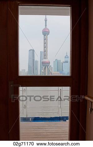 Stock Image - Oriental Pearl Tower viewed from a cruise ship, Huangpu River, Pudong, Shanghai, China. Fotosearch