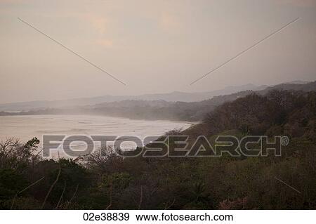 overcast evening landscape of the ocean from the jungle hilltop View Large Photo Image Stock Photo - overcast evening landscape of the ocean from the jungle hilltop. Fotosearch