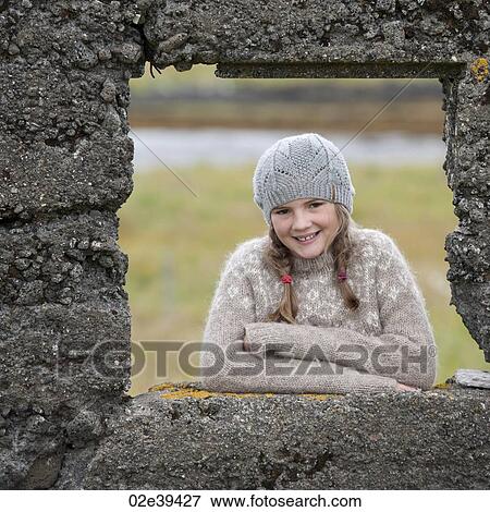 Portrait of girl through rock wall window frame View Large Photo Image Stock Photo - Portrait of girl through rock wall window frame. Fotosearch