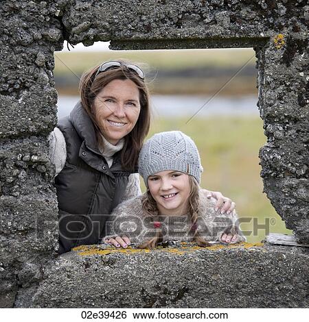 Portrait of mother and daughter through distressed rock wall window frame View Large Photo Image Stock Photograph - Portrait of mother and daughter through distressed rock wall window frame. Fotosearch