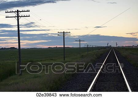 Railway tracks and hydro poles against twilight sky at Lake of the Woods, Ontario View Large Photo Image Stock Image - Railway tracks and hydro poles against twilight sky at Lake of the Woods, Ontario. Fotosearch