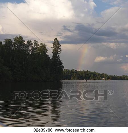 Rainbow in the sky over Lake of the Woods, Ontario View Large Photo Image Stock Photograph - Rainbow in the sky over Lake of the Woods, Ontario. Fotosearch