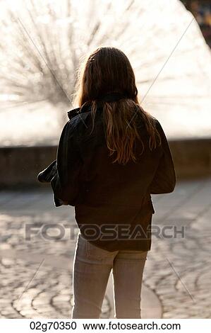 Rear view of a teenage girl looking at fountain, National Theatre, Oslo, Norway View Large Photo Image Stock Image - Rear view of a teenage girl looking at fountain, National Theatre, Oslo, Norway. Fotosearch