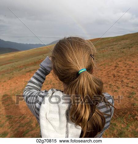 Rear view of a teenage girl looking at mountain view, Sacred Valley, Cusco Region, Peru View Large Photo Image Stock Photography - Rear view of a teenage girl looking at mountain view, Sacred Valley, Cusco Region, Peru. Fotosearch