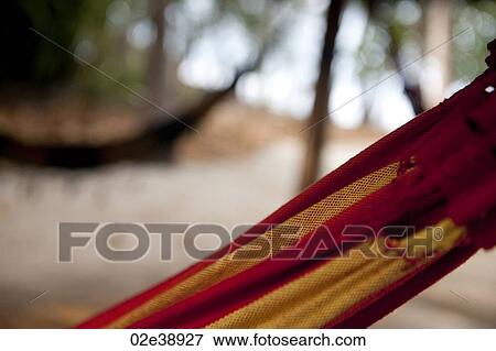 Red and yellow striped hammock detail with unfocused hammock in the background View Large Photo Image Stock Photo - Red and yellow striped hammock detail with unfocused hammock in the background. Fotosearch