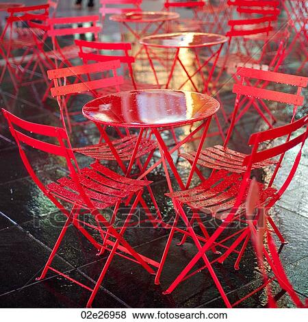 Red tables and chairs on a wet pavement. View Large Photo Image Stock Photo - Red tables and chairs on a wet pavement. . Fotosearch