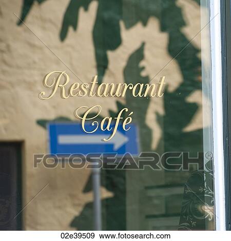 Refelction of arrow street sign in restaurant window View Large Photo Image Stock Photo - Refelction of arrow street sign in restaurant window. Fotosearch