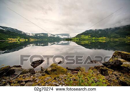 Reflection of mountains in the lake, Granvinsvatnet, Granvin, Hordaland County, Norway View Large Photo Image Picture - Reflection of mountains in the lake, Granvinsvatnet, Granvin, Hordaland County, Norway. Fotosearch