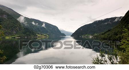 Reflection of mountains in the lake, Granvinsvatnet, Granvin, Hordaland County, Norway View Large Photo Image Stock Photograph - Reflection of mountains in the lake, Granvinsvatnet, Granvin, Hordaland County, Norway. Fotosearch