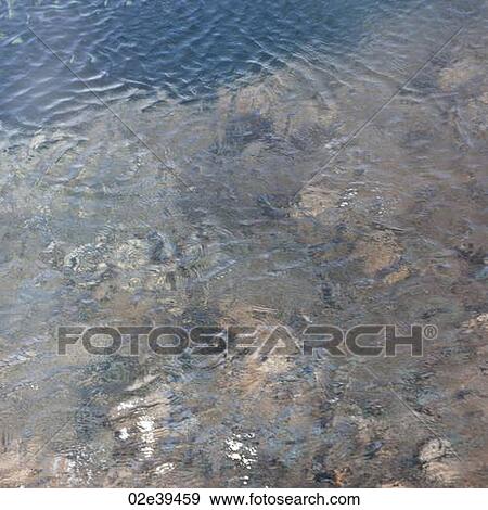 Rippling pool of water and stones View Large Photo Image Stock Photo - Rippling pool of water and stones. Fotosearch