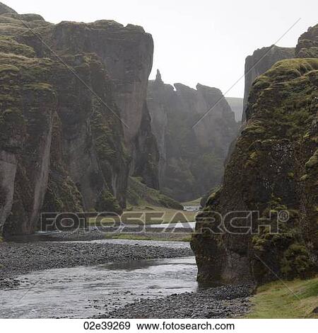 River running past steep rugged cliffs View Large Photo Image Stock Photo - River running past steep rugged cliffs. Fotosearch