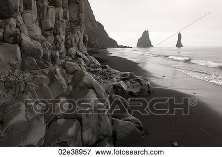 Rockface along the beach on a cloudy day View Large Photo Image Stock Photo - Rockface along the beach on a cloudy day. Fotosearch