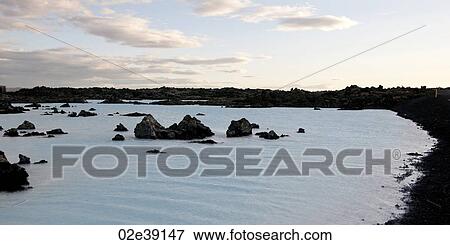 Rocks rising from the water along shore of lagoon View Large Photo Image Stock Photo - Rocks rising from the water along shore of lagoon. Fotosearch