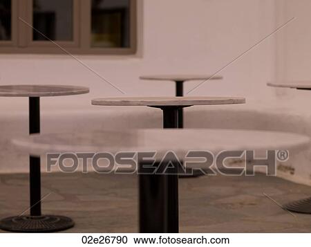 Stock Image - Round tables in Mykonos Greece. Fotosearch