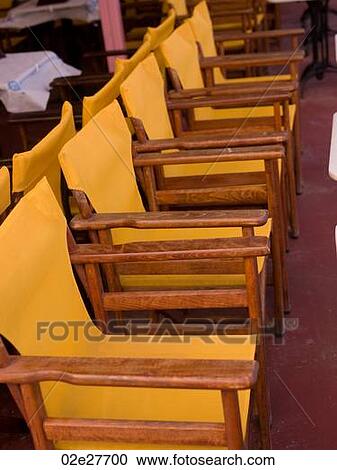 Row of yellow chairs in Santorini Greece View Large Photo Image Stock Image - Row of yellow chairs in Santorini Greece. Fotosearch