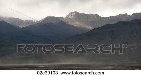 Rugged misty mountains rising from the ocean coastline View Large Photo Image Stock Image - Rugged misty mountains rising from the ocean coastline. Fotosearch