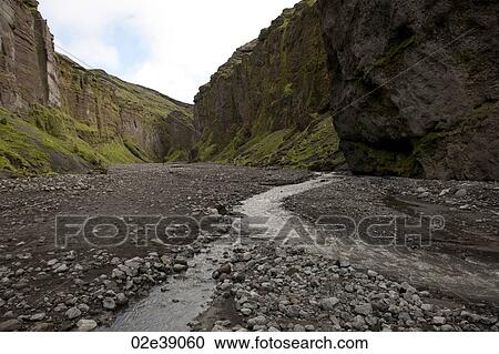 Rugged mountain canyon landscape with rocky riverbed and stream View Large Photo Image Stock Image - Rugged mountain canyon landscape with rocky riverbed and stream. Fotosearch