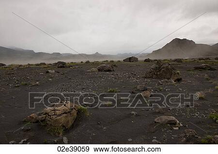 Rugged mountain landscape with dry riverbed and dust rising View Large Photo Image Stock Photo - Rugged mountain landscape with dry riverbed and dust rising. Fotosearch