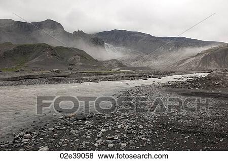 Rugged mountain landscape with river and mist rising View Large Photo Image Stock Photo - Rugged mountain landscape with river and mist rising. Fotosearch