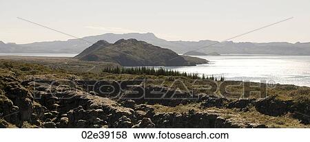 Rugged volcanic mountain landscape, moraine debris at the coastline View Large Photo Image Stock Photo - Rugged volcanic mountain landscape, moraine debris at the coastline. Fotosearch