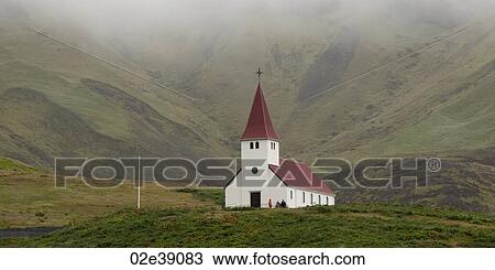 Stock Image - Rural church in grassy valley with mist. Fotosearch