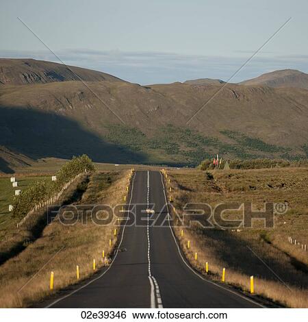 Rural farmland asphalt highway disappearing into countryside toward mountain View Large Photo Image Stock Photograph - Rural farmland asphalt highway disappearing into countryside toward mountain. Fotosearch