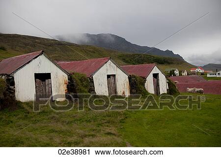 Rusted white farm sheds with corrugated red roofs on a foggy hillside with houses and sheep in the background, and clouds coming over the hills View Large Photo Image Stock Image - Rusted white farm sheds with corrugated red roofs on a foggy hillside with houses and sheep in the background, and clouds coming over the hills. Fotosearch
