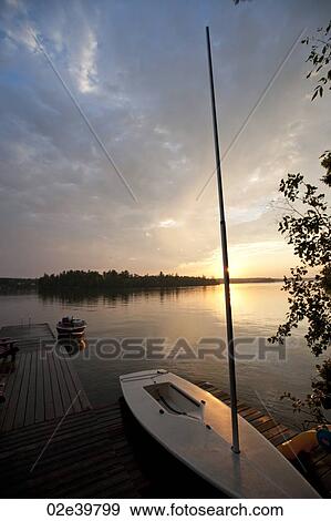 Sailboat at the dock with the sunset in background at Lake of the Woods, Ontario View Large Photo Image Stock Photo - Sailboat at the dock with the sunset in background at Lake of the Woods, Ontario. Fotosearch