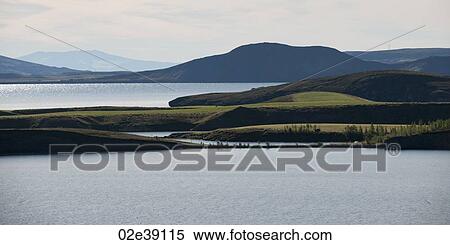 Seascape, ocean and mountains on a serene day View Large Photo Image Stock Photography - Seascape, ocean and mountains on a serene day. Fotosearch