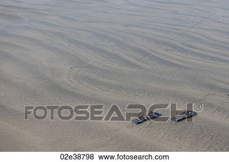 Shoes on sand View Large Photo Image Stock Photo - Shoes on sand. Fotosearch