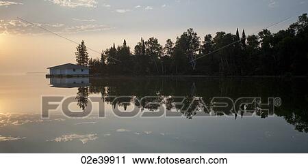Stock Image - Shoreline at twilight in Lake of the Woods, Ontario. Fotosearch