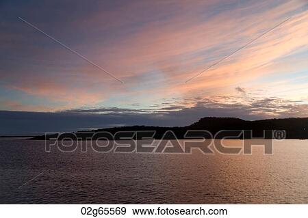 Silhouette of an island at dusk, Puerto Baquerizo Moreno, San Cristobal Island, Galapagos Islands, Ecuador View Large Photo Image Stock Photo - Silhouette of an island at dusk, Puerto Baquerizo Moreno, San Cristobal Island, Galapagos Islands, Ecuador. Fotosearch