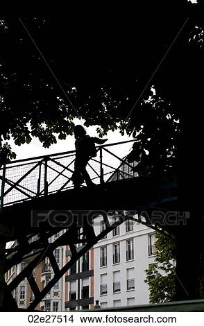 Silhouette of person crossing a bridge in Paris France View Large Photo Image Picture - Silhouette of person crossing a bridge in Paris France. Fotosearch