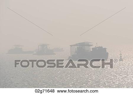 Silhouette of ships in the East China Sea, Tianjin, China View Large Photo Image Stock Photo - Silhouette of ships in the East China Sea, Tianjin, China. Fotosearch