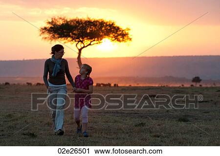 Sillouette of people against sunset sky in Kenya View Large Photo Image Stock Image - Sillouette of people against sunset sky in Kenya. Fotosearch