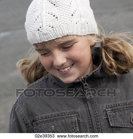 Smiling blond girl outside in woolen cap and demin jacket View Large Photo Image Stock Image - Smiling blond girl outside in woolen cap and demin jacket. Fotosearch
