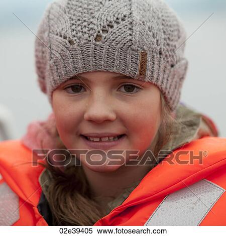 Smiling girl in fluorescent orange life preserver and knit lace cap View Large Photo Image Stock Photography - Smiling girl in fluorescent orange life preserver and knit lace cap. Fotosearch