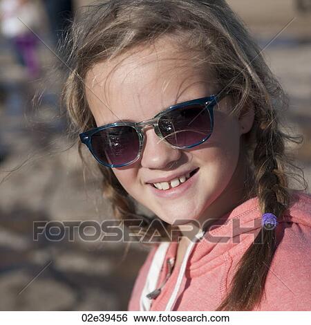 Smiling girl in sunglasses and braids View Large Photo Image Stock Photograph - Smiling girl in sunglasses and braids. Fotosearch