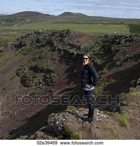 Smiling woman in sunglasses on rock outcrop on eroding hillside in rural countryside View Large Photo Image Stock Photo - Smiling woman in sunglasses on rock outcrop on eroding hillside in rural countryside. Fotosearch