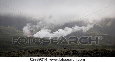Smoke rising from valleys into clouded mountains View Large Photo Image Picture - Smoke rising from valleys into clouded mountains. Fotosearch
