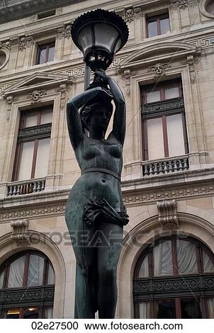Stock Image - Staute lampposts at the Palace Garnier in Paris France. Fotosearch