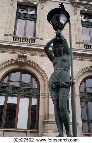 Stock Image - Staute lampposts at the Palace Garnier in Paris France. Fotosearch